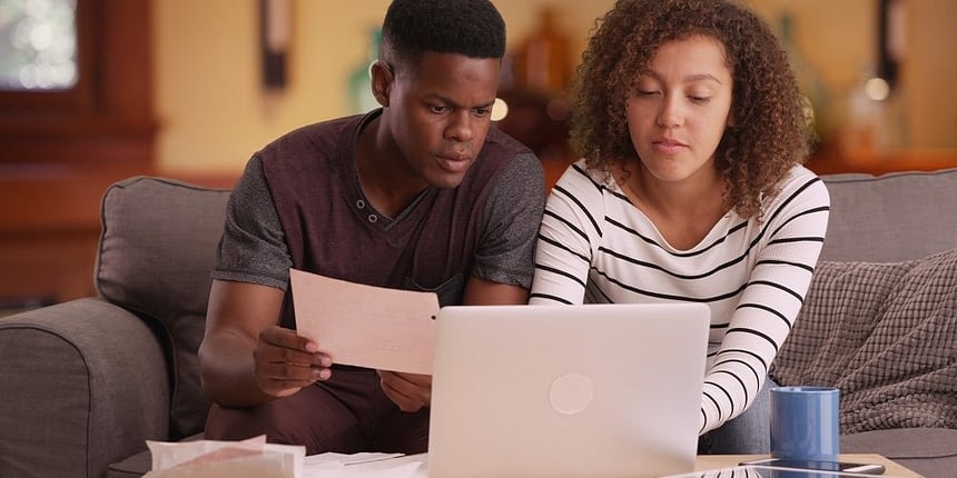 young couple working on documents on laptop