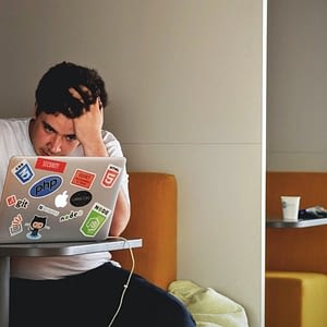 person frustrated looking at laptop