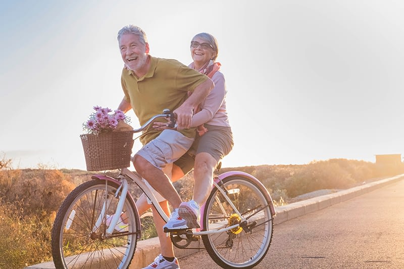 retired couple riding bike
