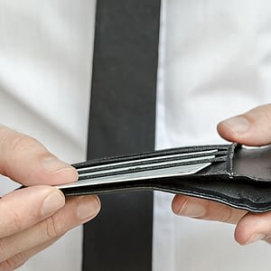 man looking into his wallet