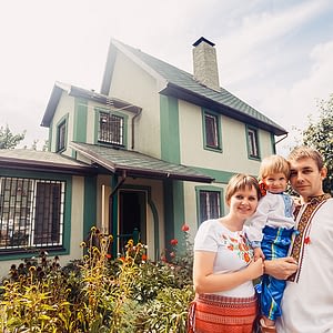 ukrainian family infront of their home